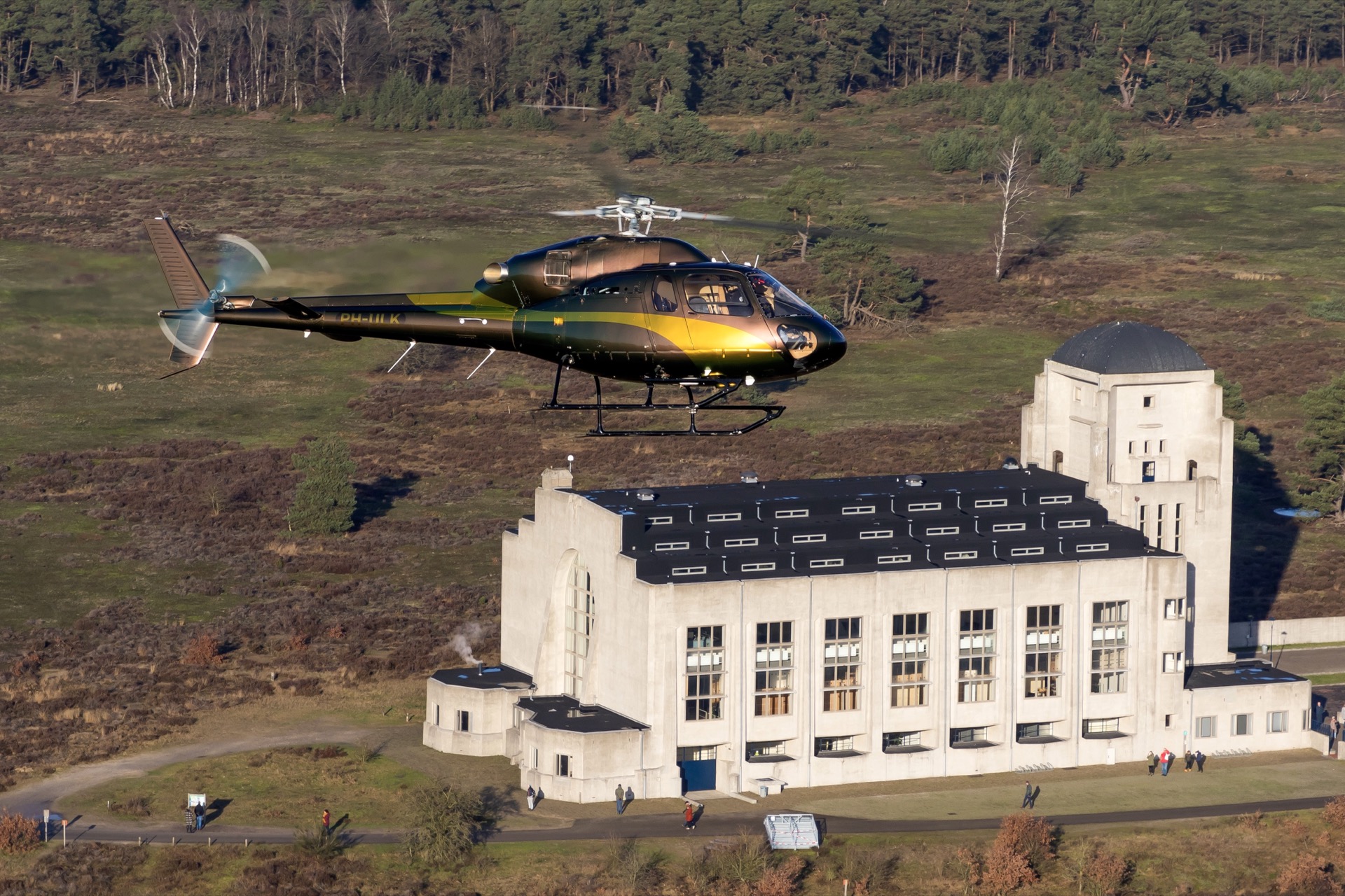 Private helicopter flying over a Dutch landscape, helicopter experience gift