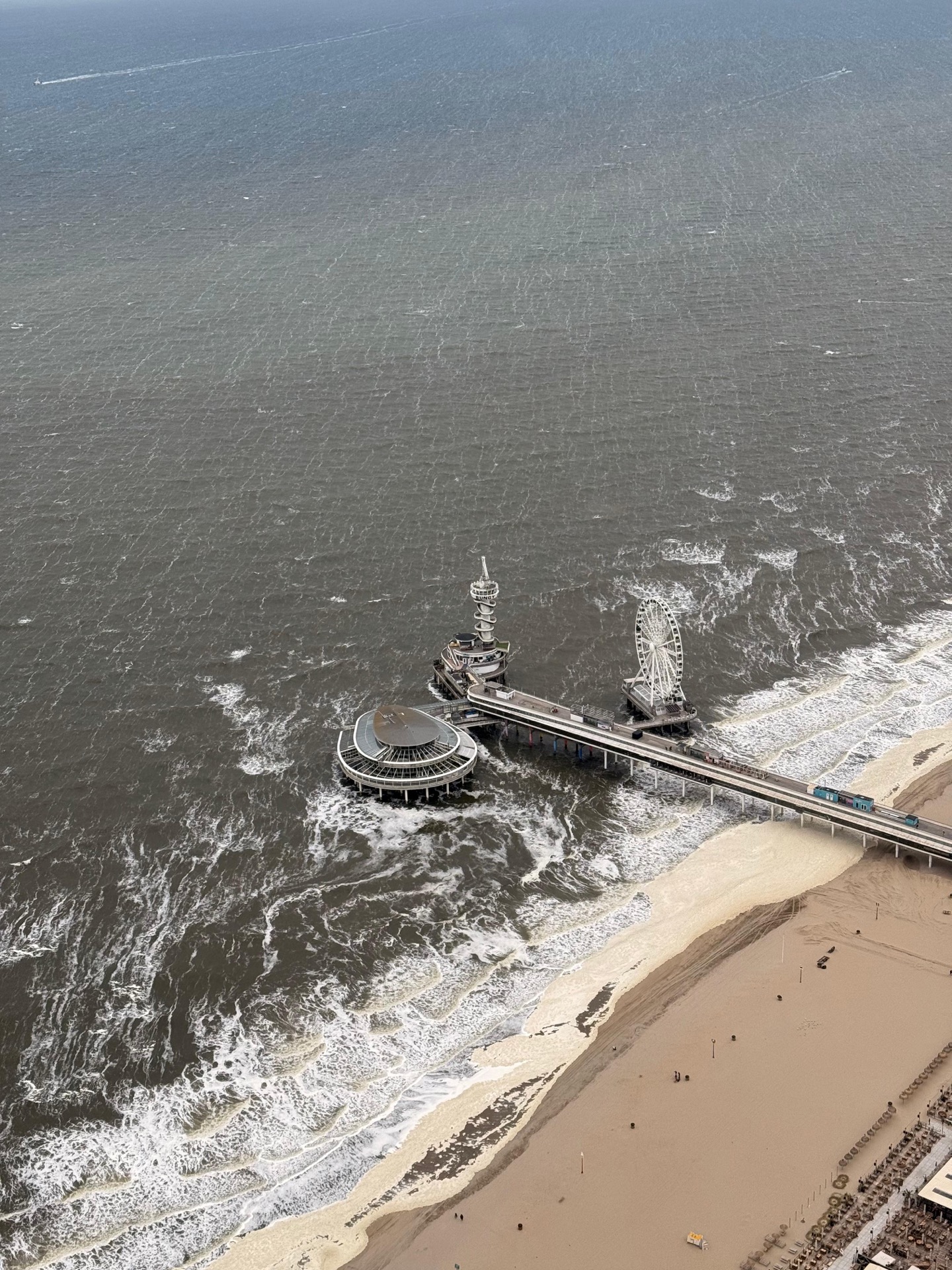 Aerial view of Pier Scheveningen along the Dutch coast from a helicopter